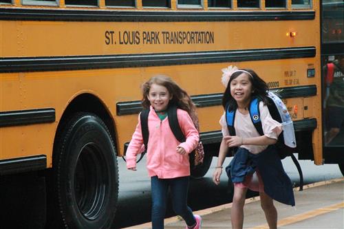 Two kids getting off of a St. Louis school bus